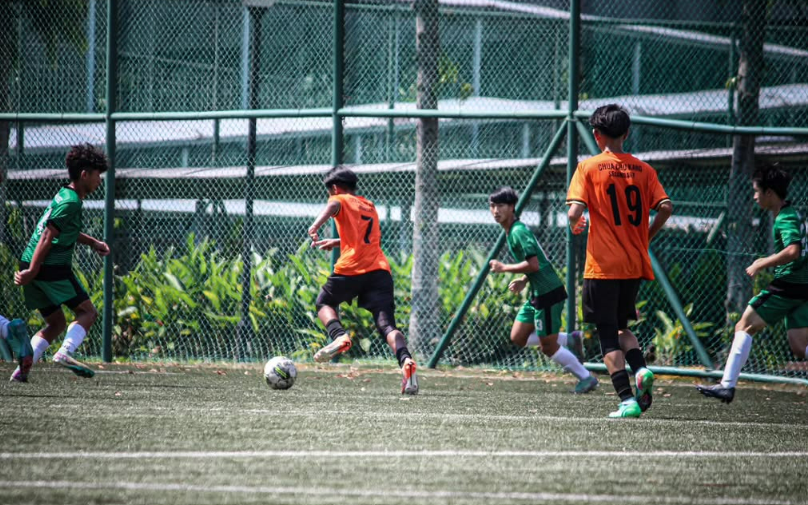 CCKSS football team in action during a competitive school football match.
